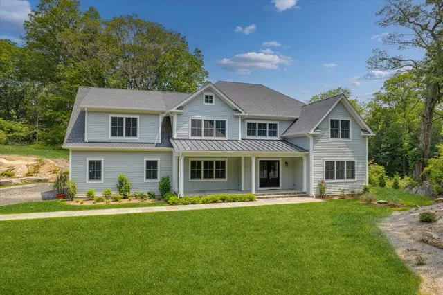 a front view of house with yard and green space