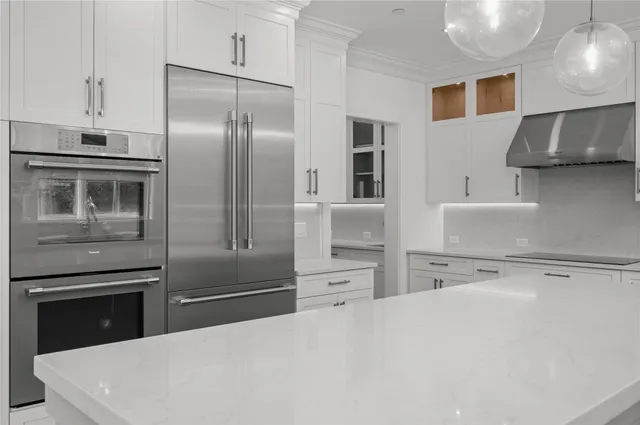 a kitchen with stainless steel appliances a refrigerator sink and stove