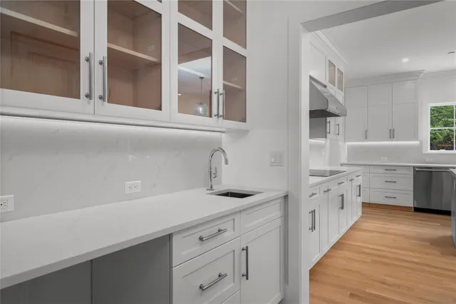 a kitchen with granite countertop white cabinets and white appliances
