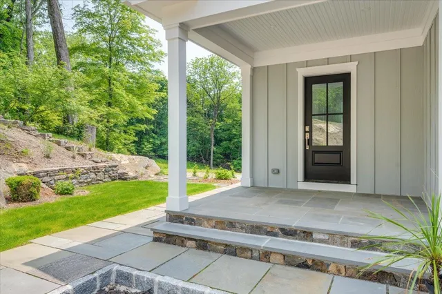 a backyard of a house with table and chairs