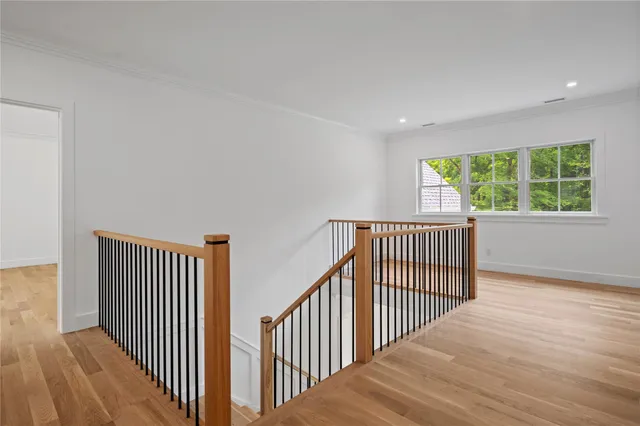 a view of a hallway with window and stairs