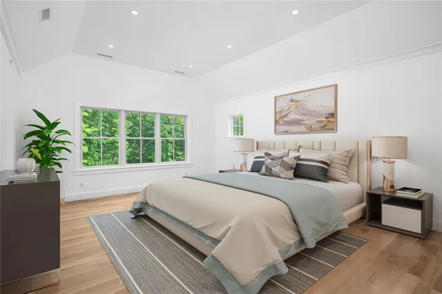 a spacious bedroom with a large bed and a large window