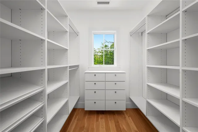a room with walk in closet and window