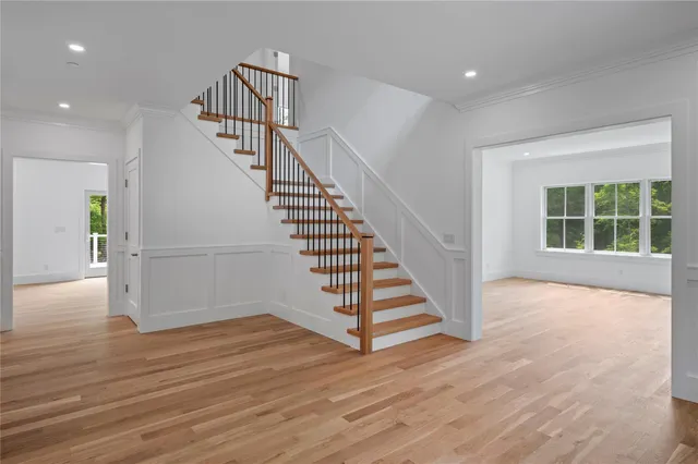a view of entryway and hall with wooden floor