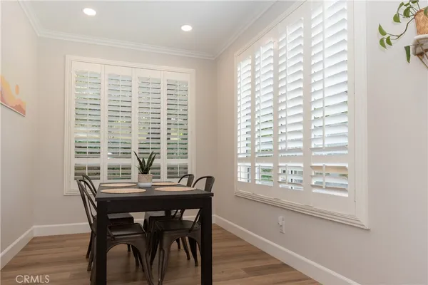a kitchen with granite countertop white cabinets white appliances a sink and a window