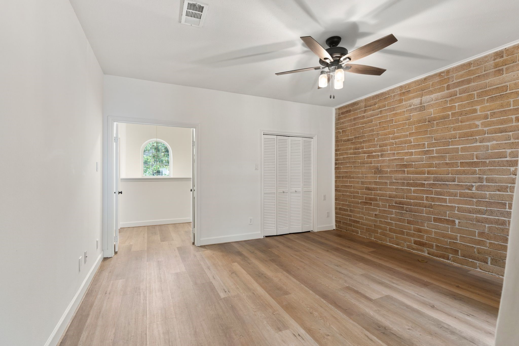153 Sage Road Houston, TX 77056 - Photo 26 of 36 Another view of secondary bedroom #2 showcasing another set of french doors to access the main stairway. There is a wall closet as well as a second walk in closet.