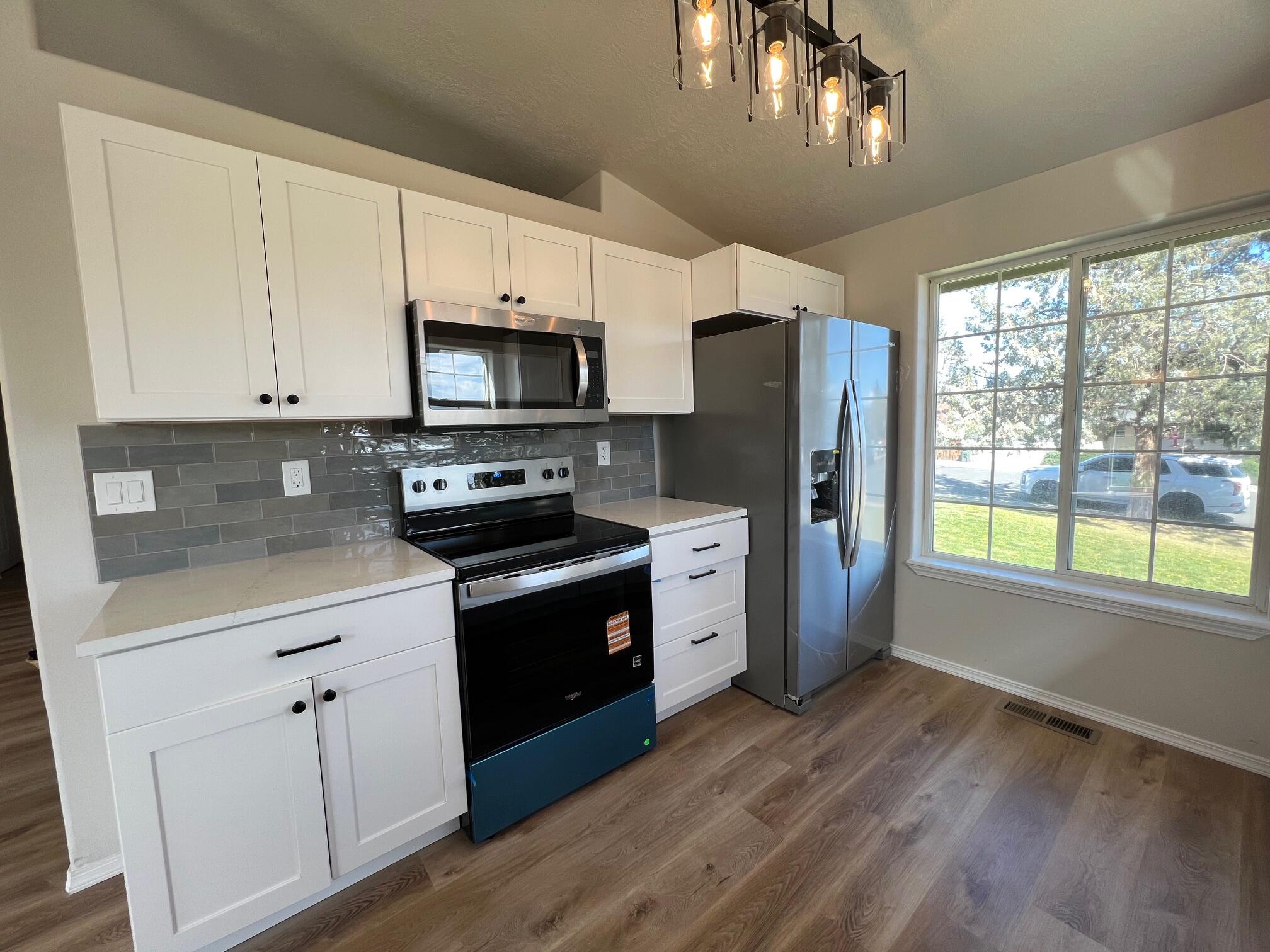 629 Deer Ridge Court Madras, OR 97741 - Photo 6 of 39 a kitchen with stainless steel appliances granite countertop a stove a sink and a refrigerator