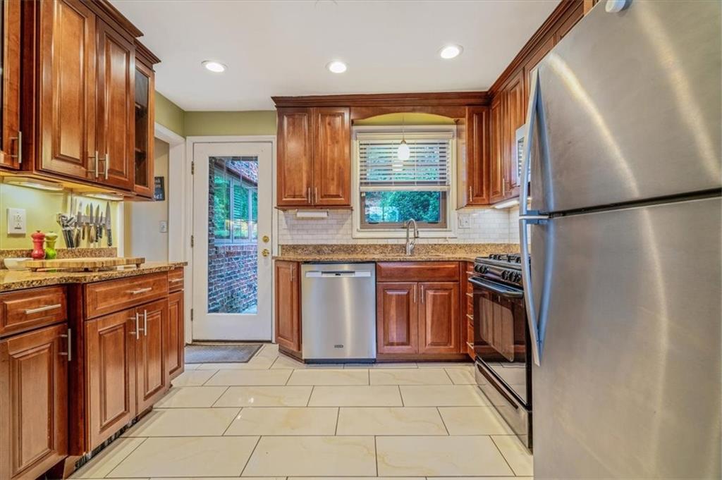 21 Marquette Road Pittsburgh, PA 15229 - Photo 13 of 44 a kitchen with stainless steel appliances granite countertop a refrigerator a sink and a stove