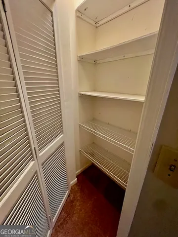 a bathroom with a granite countertop sink and mirror with bathtub
