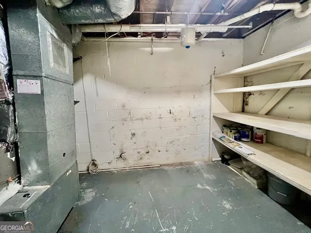 a view of empty room with wooden floor and fireplace