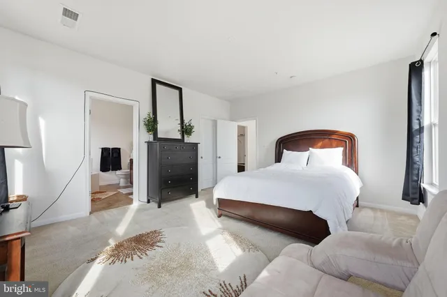 a bedroom with a bed and a television