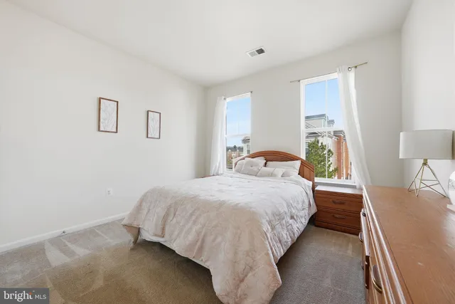 a bedroom with a bed and a lamp