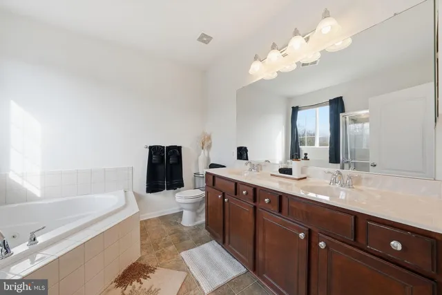 a bathroom with a bathtub and a shower