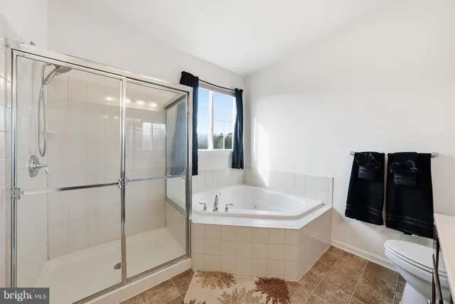 a bathroom with a bathtub and a window