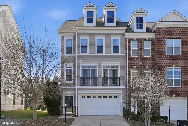 a view of a house with wooden fence