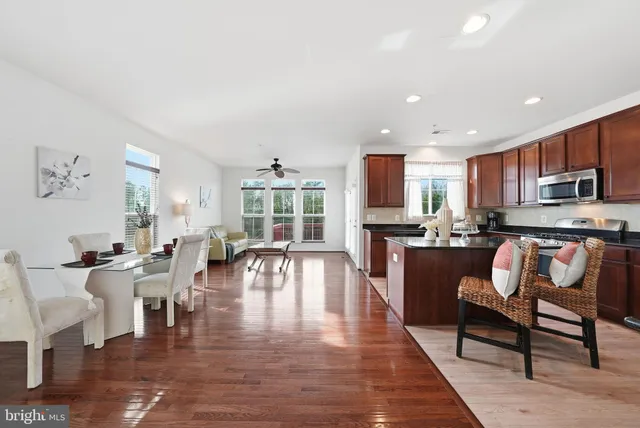 a living room with fireplace furniture and a wooden floor