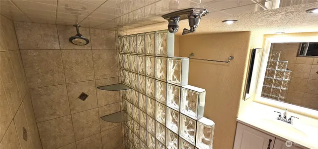 a view of walk in closet with clothes and door