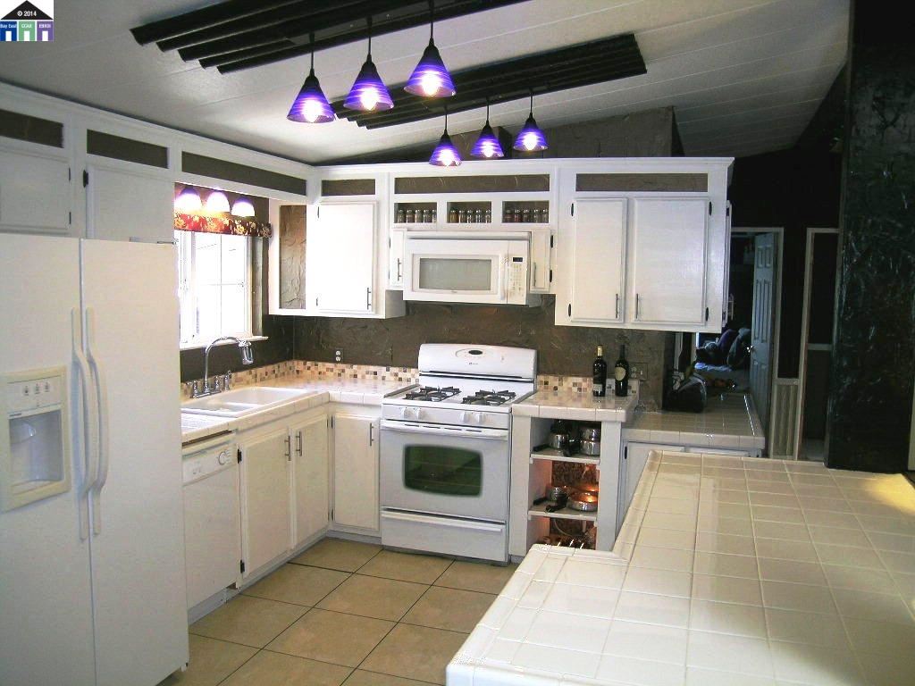 681 Tyler Island Bridge Road Isleton, CA 95641 - Photo 12 of 24 a kitchen with stainless steel appliances granite countertop a stove sink and cabinets