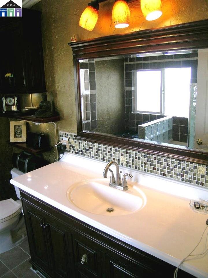 681 Tyler Island Bridge Road Isleton, CA 95641 - Photo 16 of 24 a bathroom with a sink and a mirror