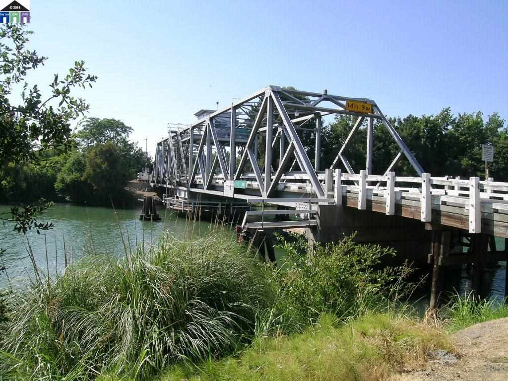 681 Tyler Island Bridge Road Isleton, CA 95641 - Photo 3 of 24 a view of house with swimming pool and outdoor seating