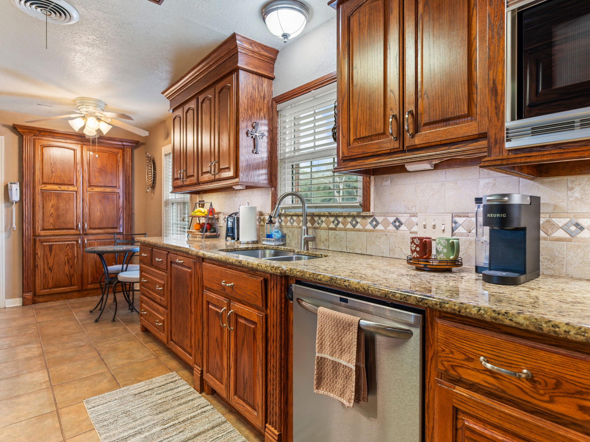 910 6th Street Bay City, TX 77414 - Photo 12 of 34 a kitchen with granite countertop stainless steel appliances a sink stove top oven and cabinets