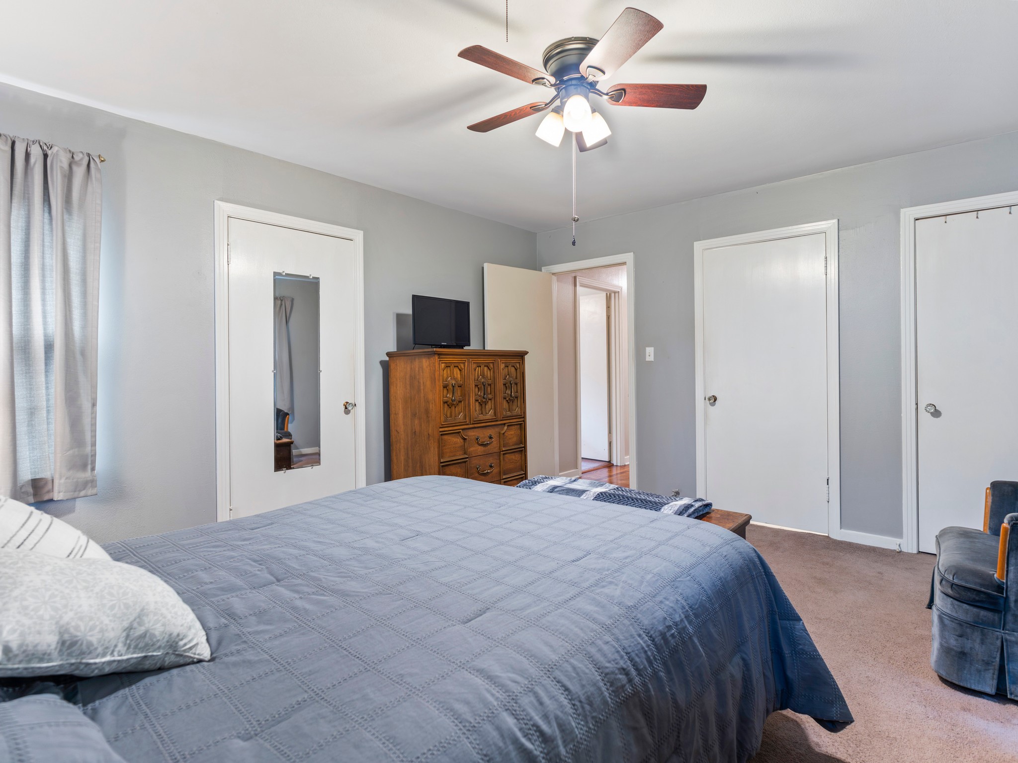 910 6th Street Bay City, TX 77414 - Photo 30 of 34 a bedroom with a large bed and a chandelier