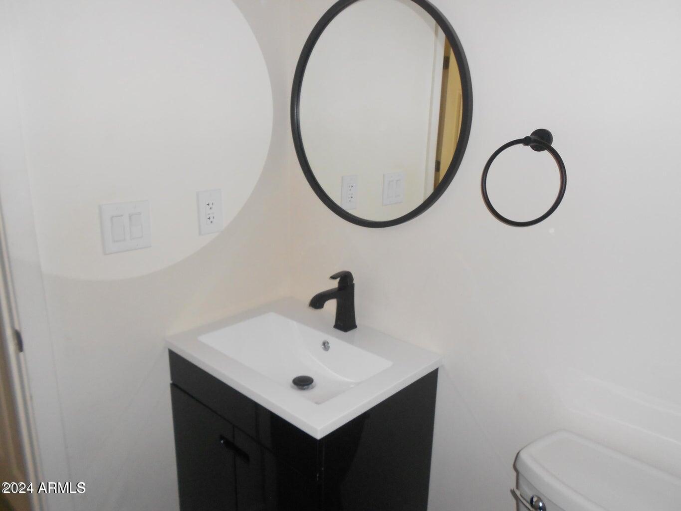 3151 North 36th Street, Unit 5 Phoenix, AZ 85018 - Photo 10 of 13 a bathroom with a sink and a mirror