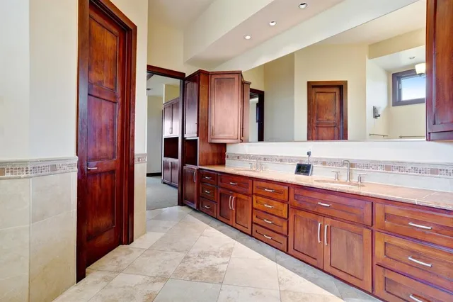 a bathroom with a tub sink and mirror