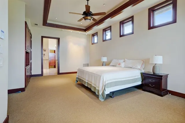 a bed room with a bed and a ceiling fan