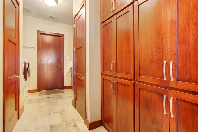 a living room with furniture a flat screen tv and a floor to ceiling window