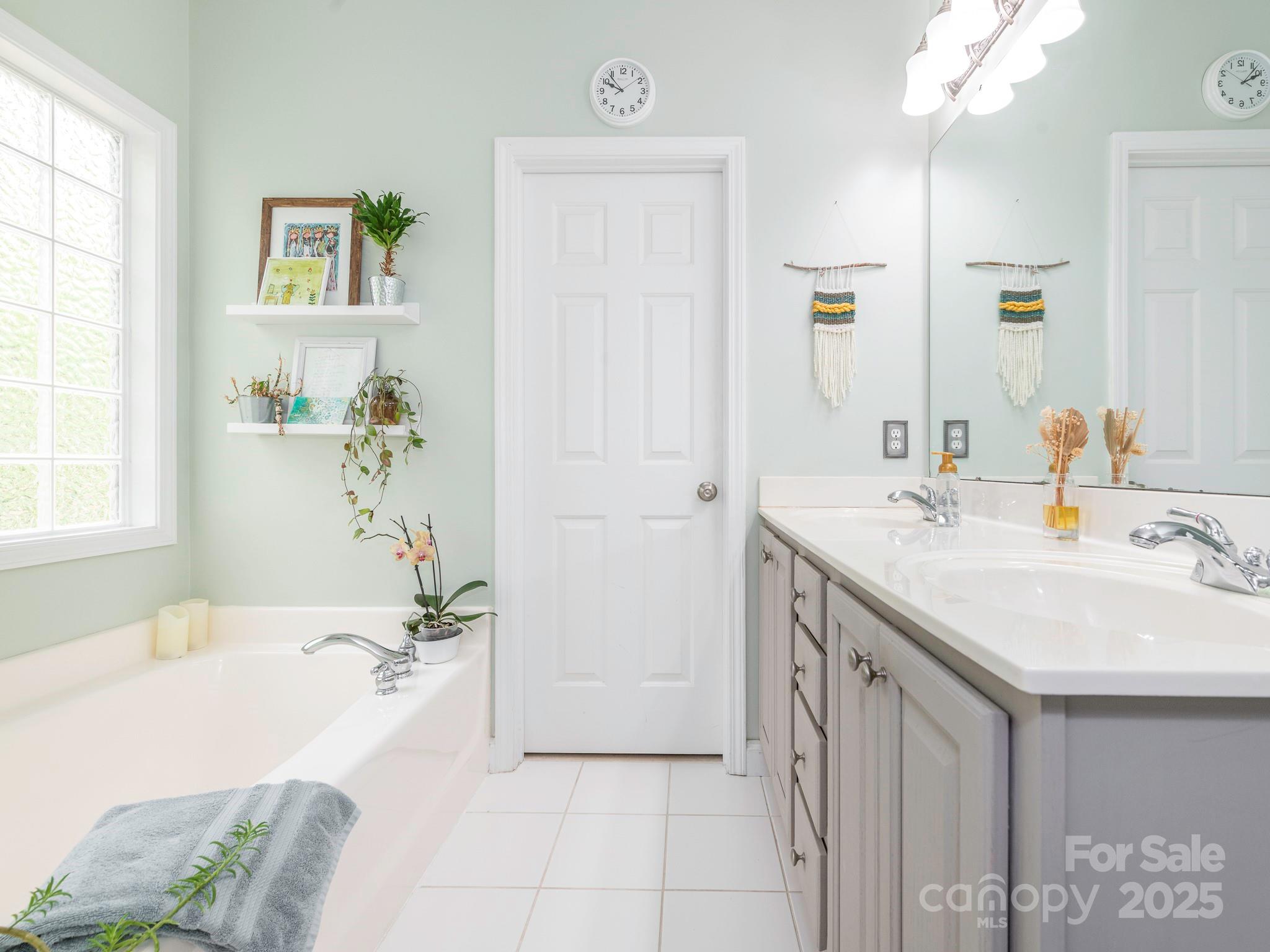 3033 Beech Court Indian Trail, NC 28079 - Photo 18 of 39 a spacious bathroom with a tub sink and mirror