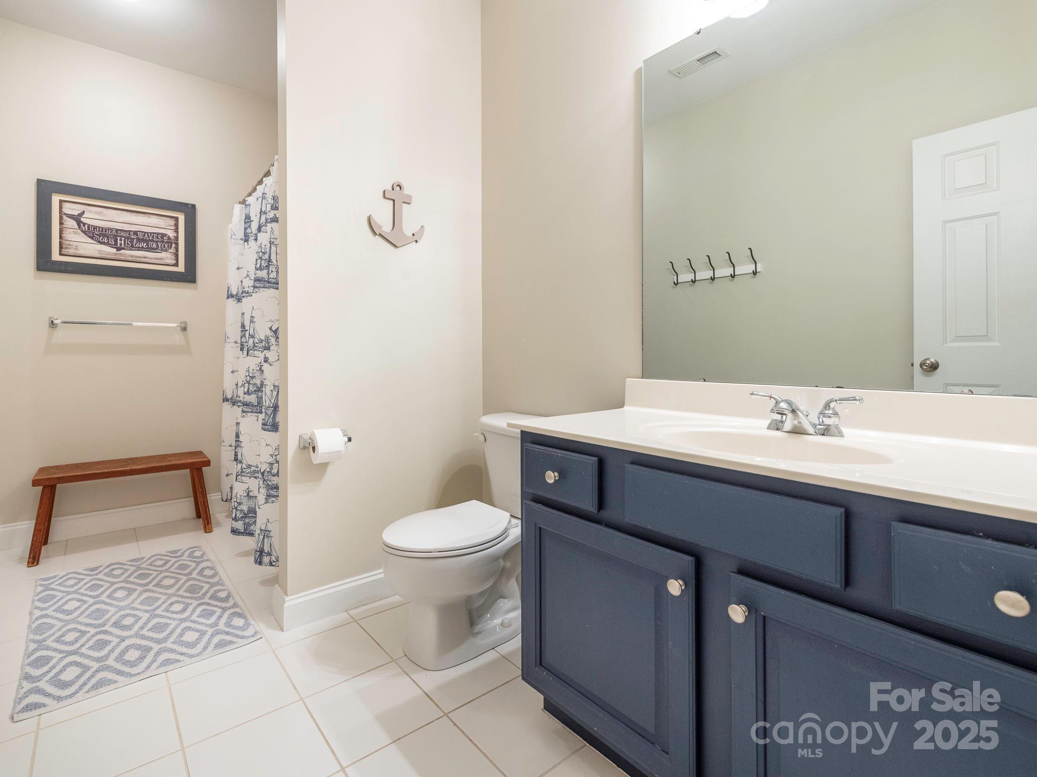 3033 Beech Court Indian Trail, NC 28079 - Photo 26 of 39 a bathroom with a sink a toilet and shower