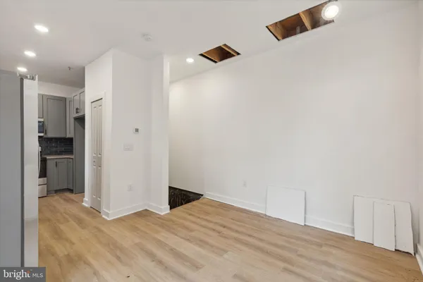 a view of empty room with wooden floor