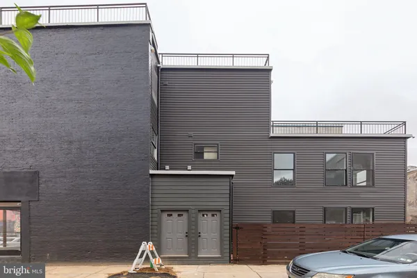 a front view of a building with parking space