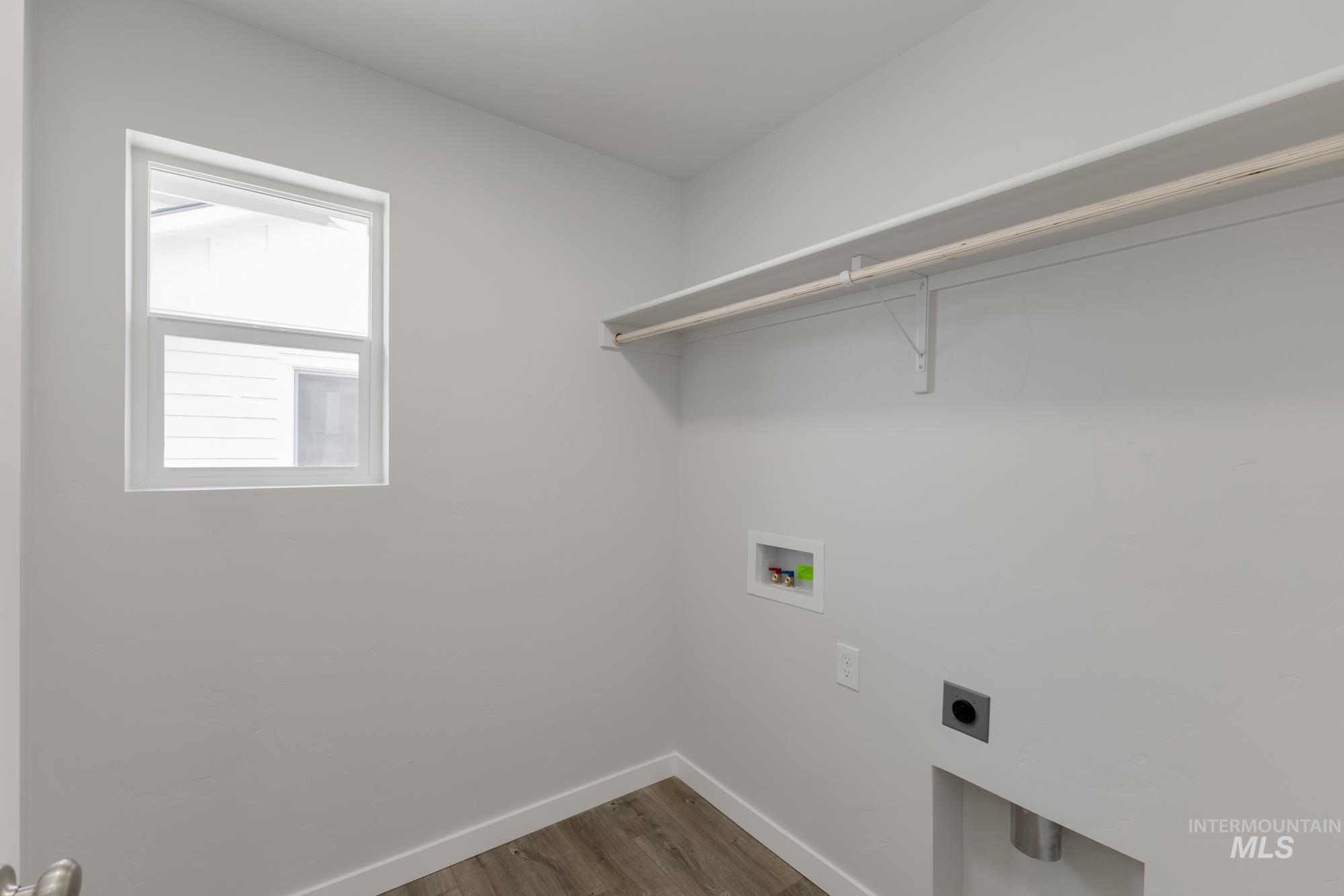 3664 West Dover Drive Meridian, ID 83642 - Photo 16 of 22 Laundry room with light wood-style flooring, washer hookup, and electric dryer hookup