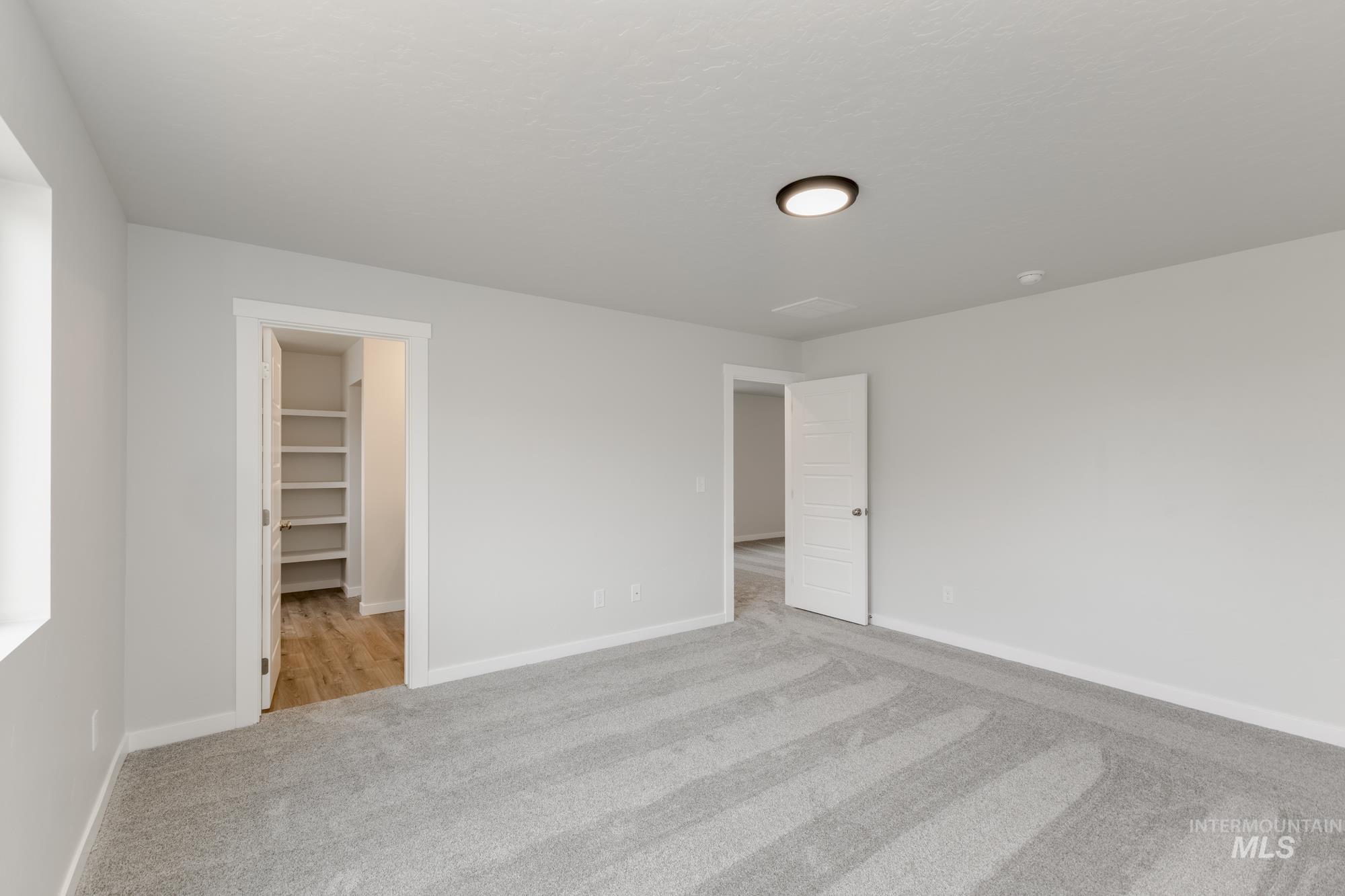 3664 West Dover Drive Meridian, ID 83642 - Photo 20 of 22 Unfurnished bedroom with a spacious closet and carpet floors