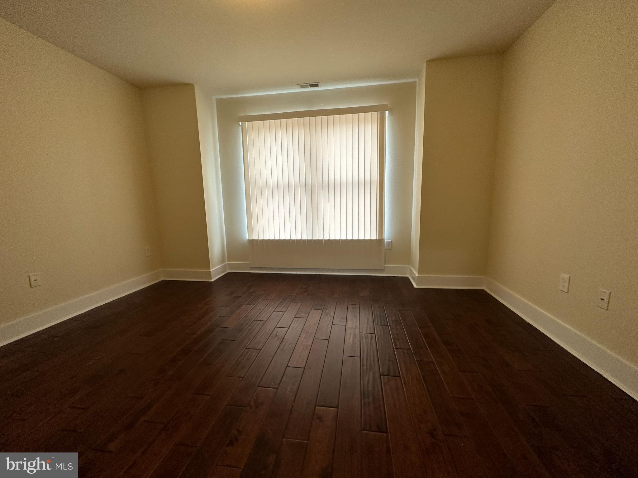 1712 North Gratz Street, Unit 2 Philadelphia, PA 19121 - Photo 11 of 18 a view of an empty room with wooden floor and a window