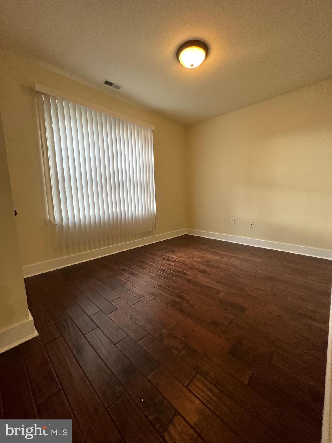 1712 North Gratz Street, Unit 2 Philadelphia, PA 19121 - Photo 7 of 18 an empty room with wooden floor and windows