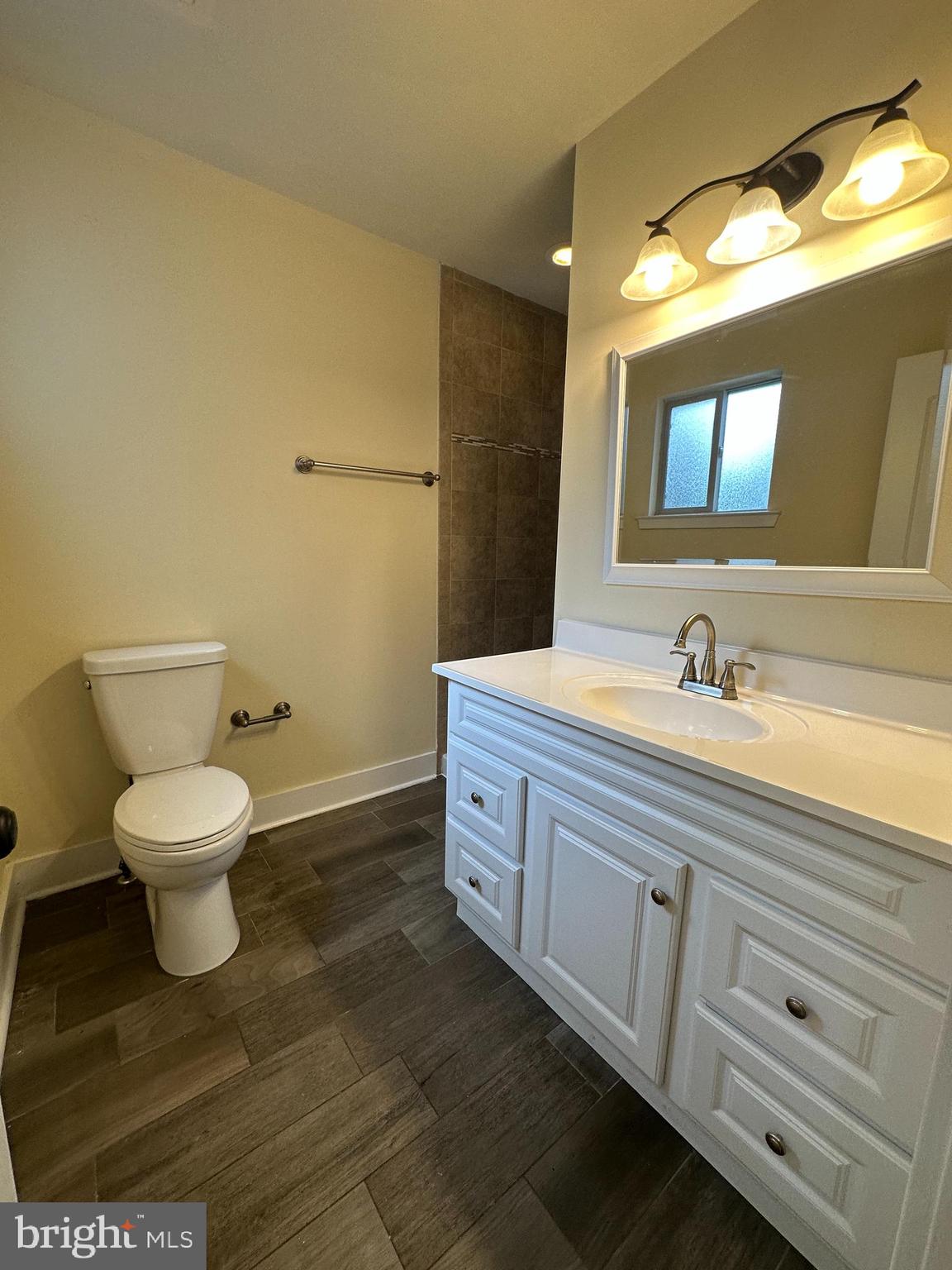1712 North Gratz Street, Unit 2 Philadelphia, PA 19121 - Photo 8 of 18 a spacious bathroom with a toilet sink and mirror