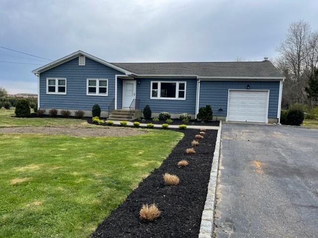 a front view of house with yard and green space