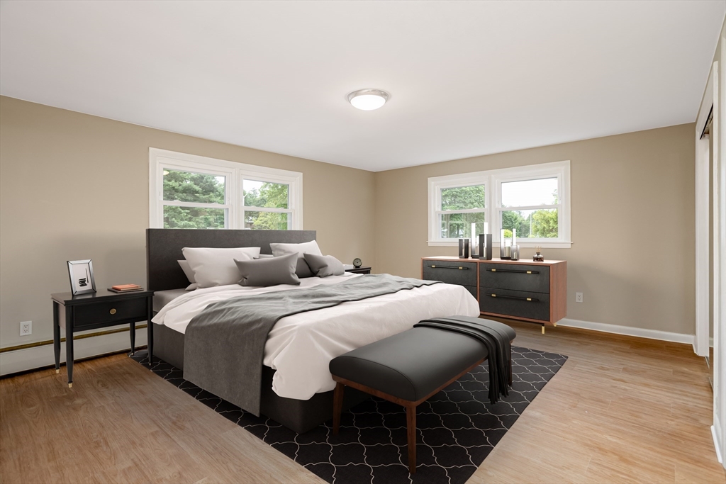 477 Salisbury Street Worcester, MA 01609 - Photo 15 of 42 a bedroom with a bed and wooden floor