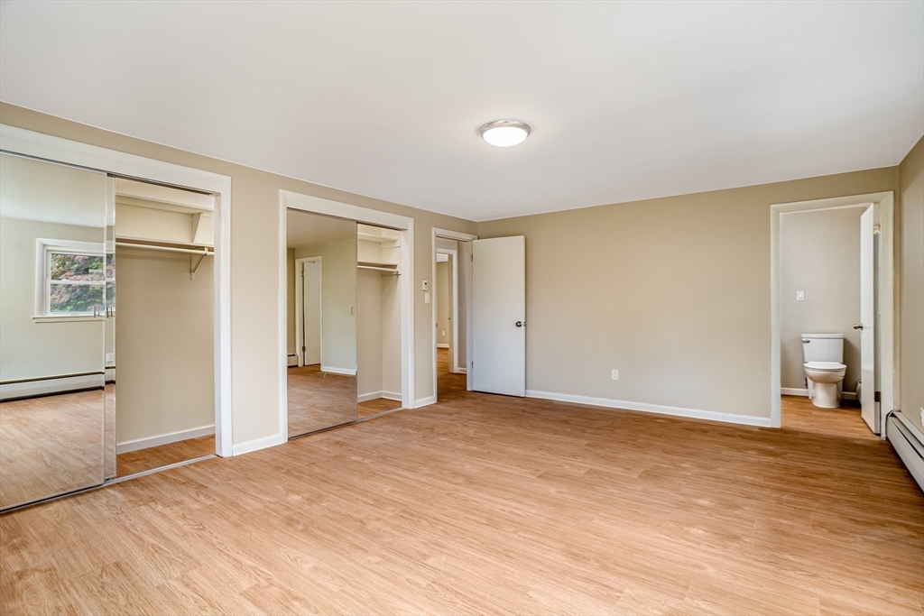477 Salisbury Street Worcester, MA 01609 - Photo 17 of 42 a view of an empty room with wooden floor and a window