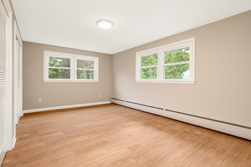 477 Salisbury Street Worcester, MA 01609 - Photo 20 of 42 an empty room with wooden floor and windows