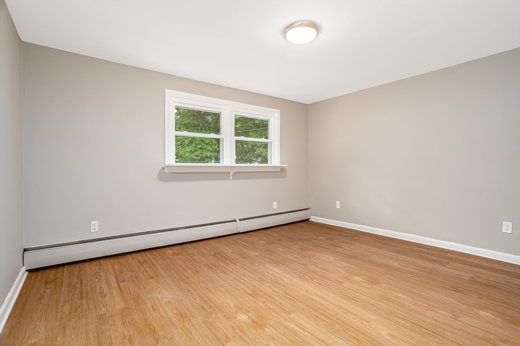 477 Salisbury Street Worcester, MA 01609 - Photo 23 of 42 an empty room with wooden floor and windows