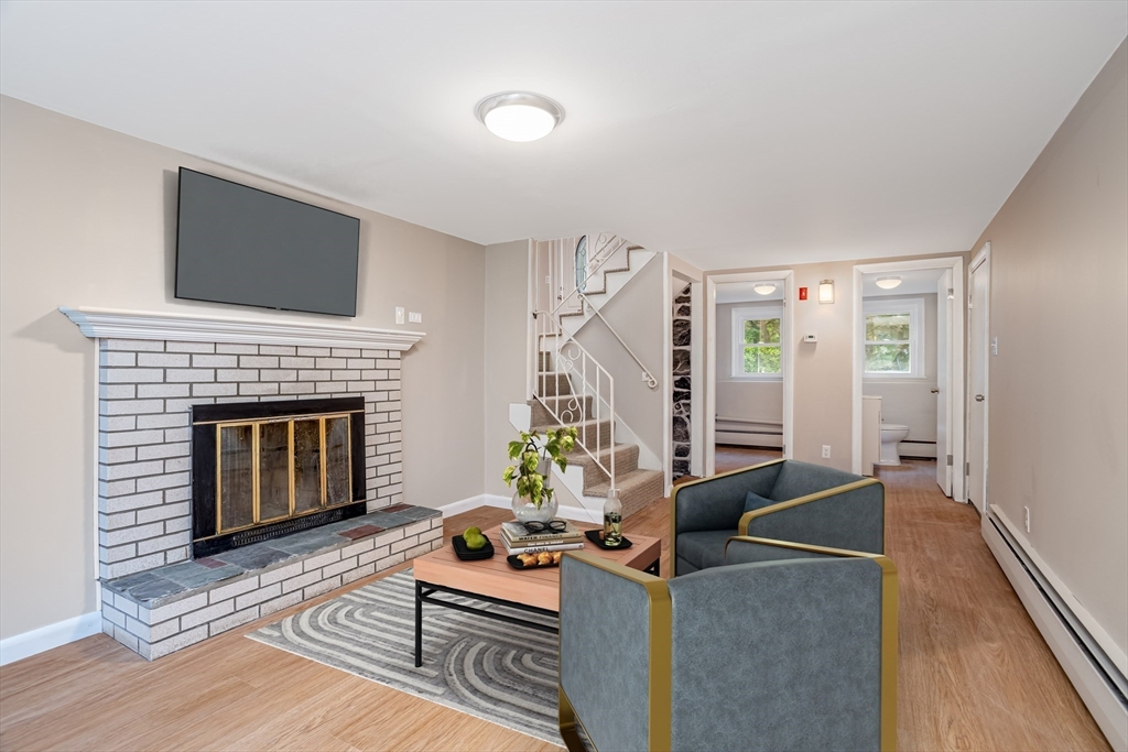 477 Salisbury Street Worcester, MA 01609 - Photo 29 of 42 a living room with furniture and a fireplace
