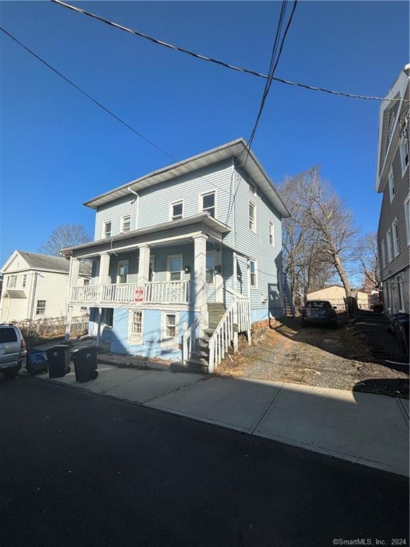 a front view of a house with sitting area