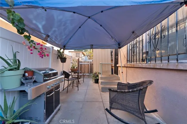 a view of a chairs and table in the balcony