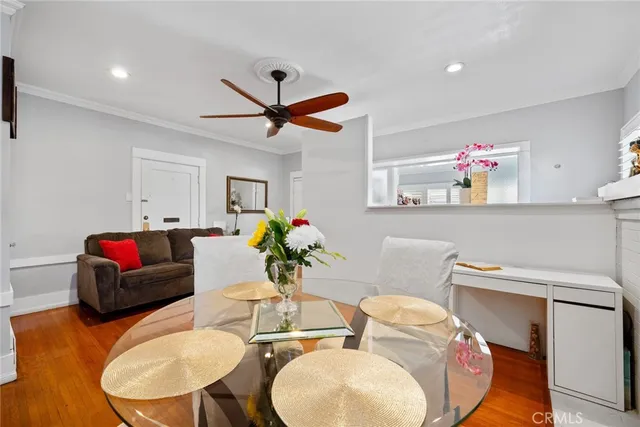 a living room with furniture flowerpot and a chandelier