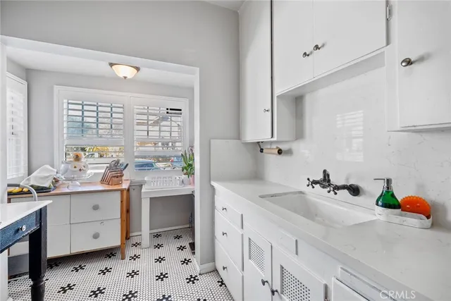 a kitchen with a sink stove and cabinets