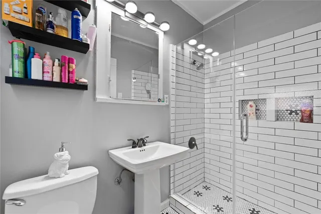 a bathroom with a sink a toilet and mirror